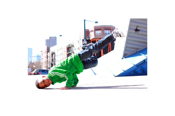 Bboy in Breaking Dance Freeze with city scape background..